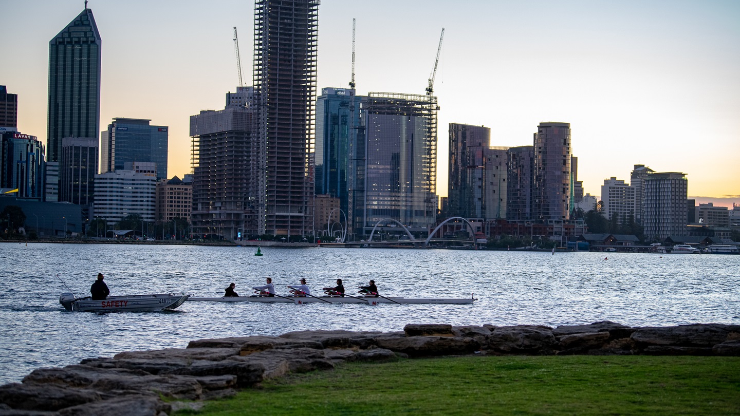 Rowing on the Swan River with the City of Perth cityscape