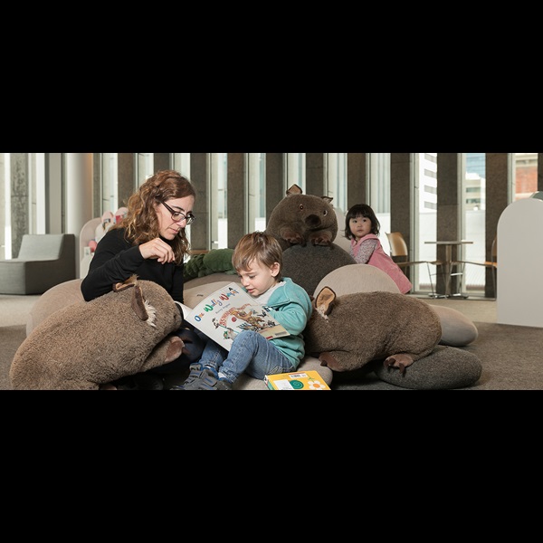 Mother and toddler reading book