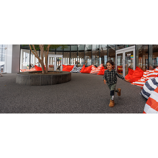 Child running through the Tree area of Level 4 of the Library.