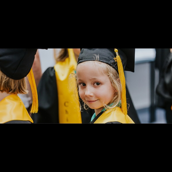 Child dressed in university robes.