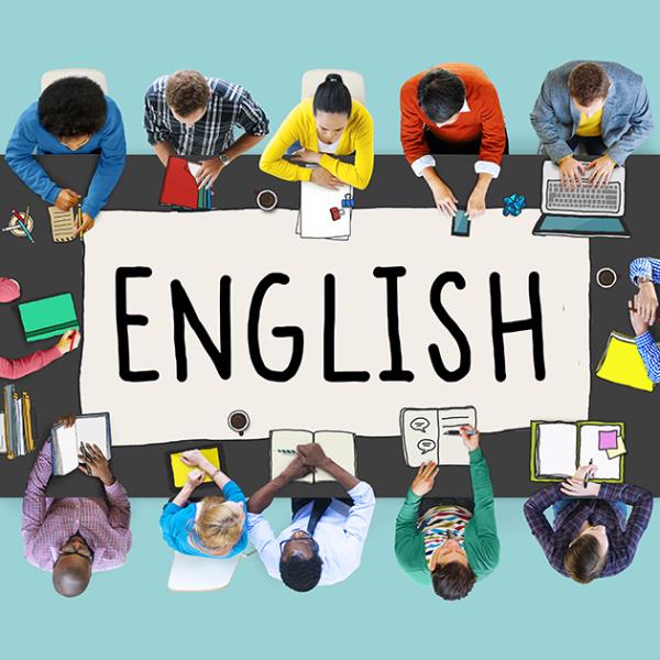 Mixed media image of a view from above of people sat around a rectangular table studying. The word English is written on the table in large letters.