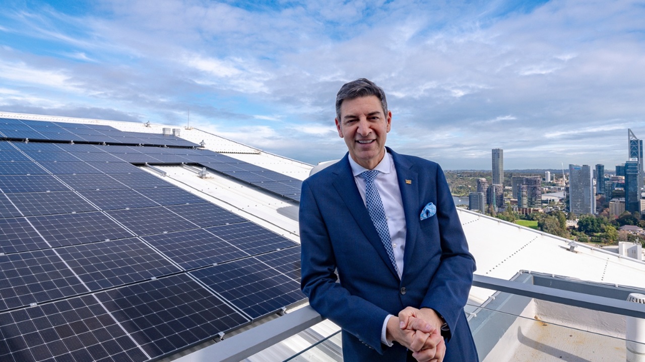 Basil Zempilas standing in front of rooftop solar panels