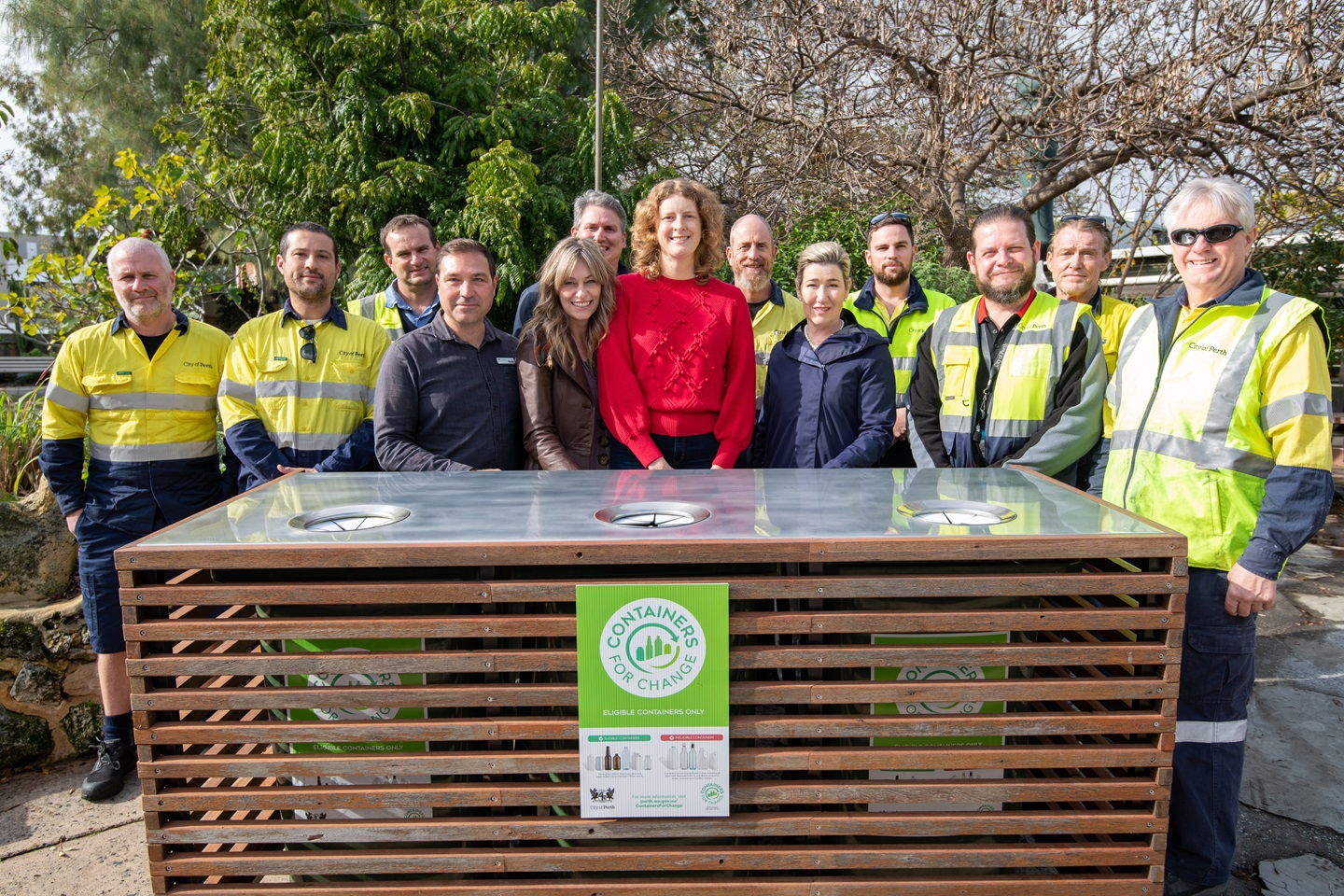 Group of people standing around a bin