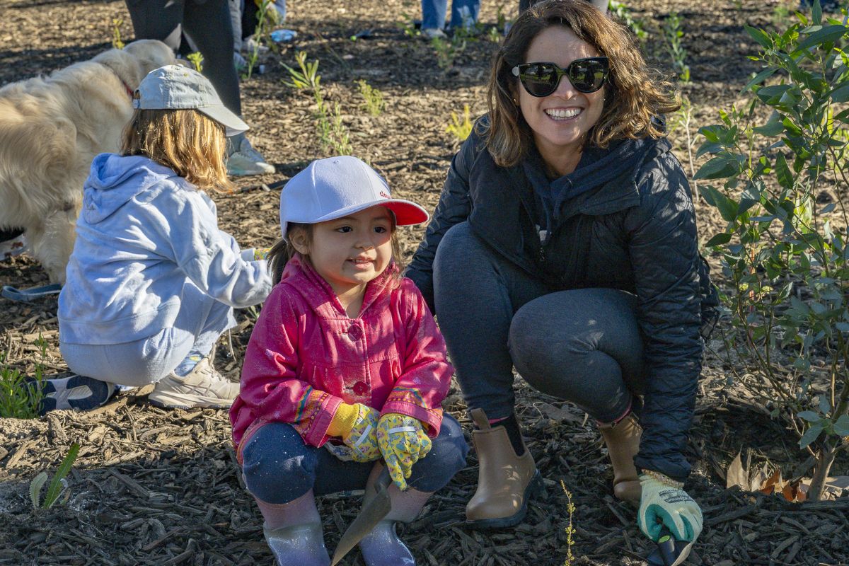 A woman and child planting trees for National Tree Day