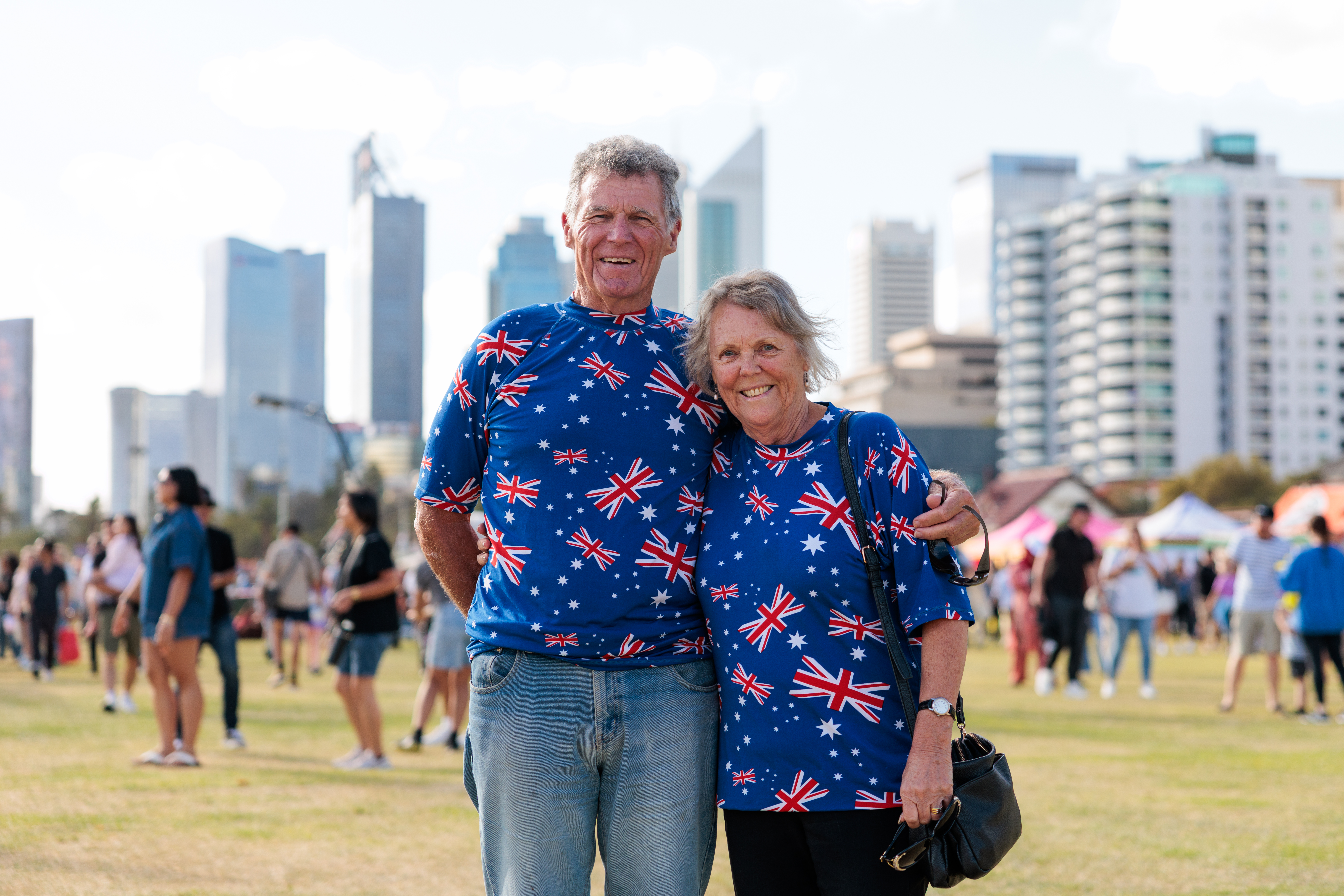 Patrons smiling wearing Australian flag merchandise at 2026 Hancock Prospecting Australia Day event.