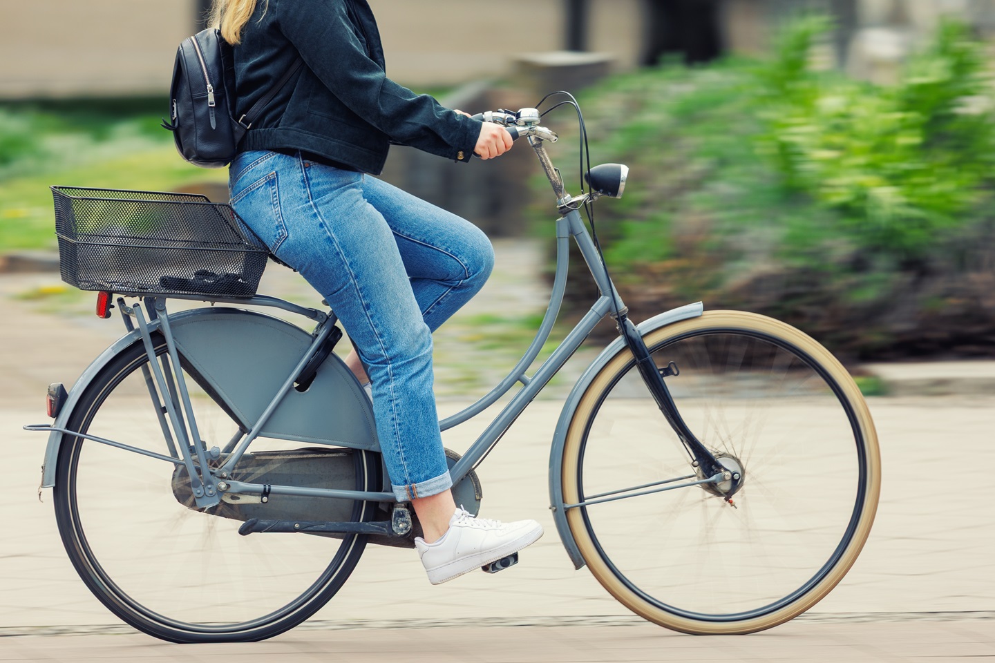 Woman cycling along a road 