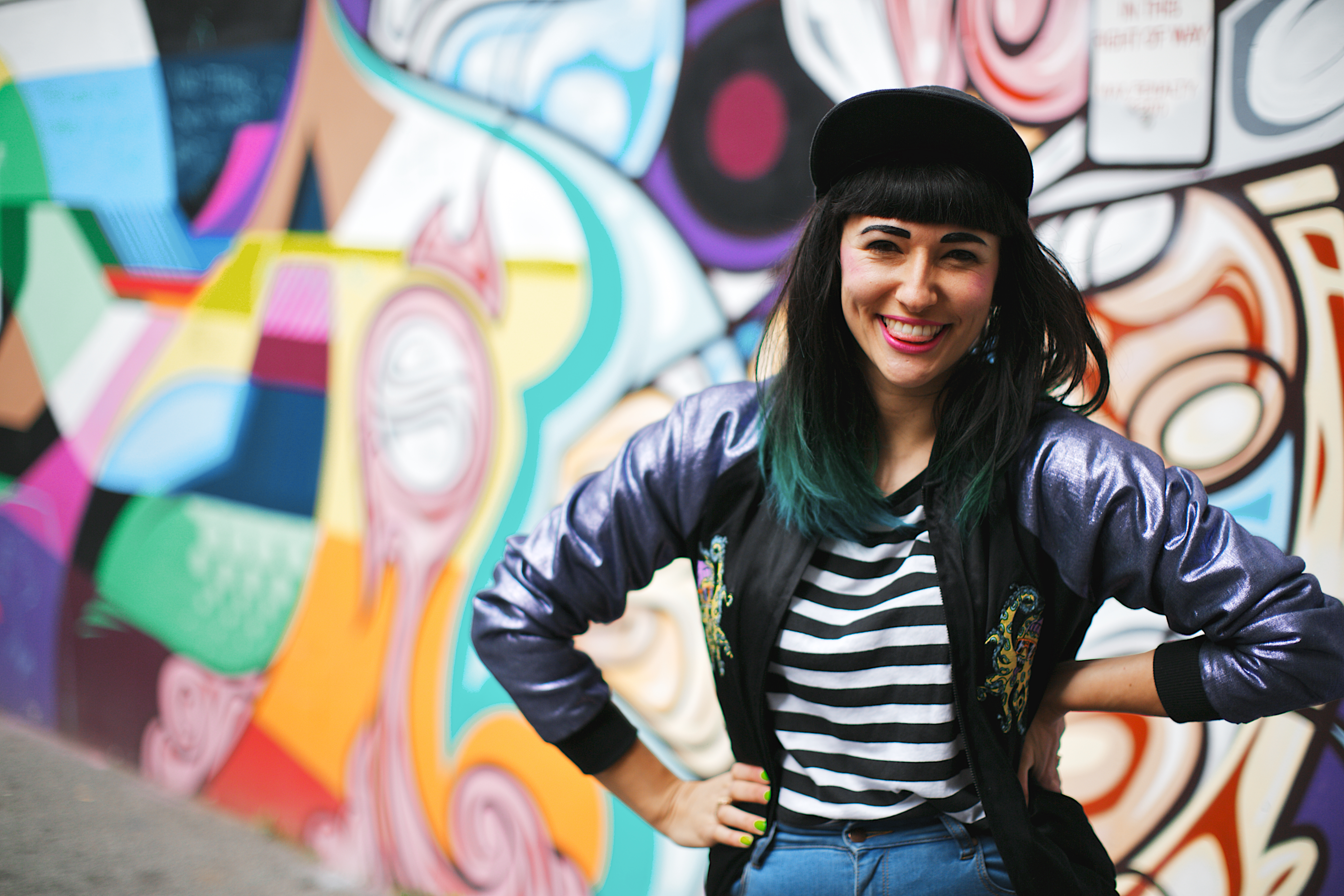 Girl smiling in front of artistic wall