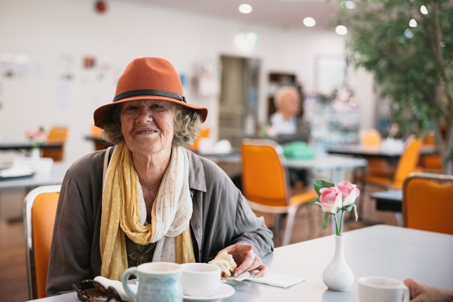Lady in hat smiles at camera