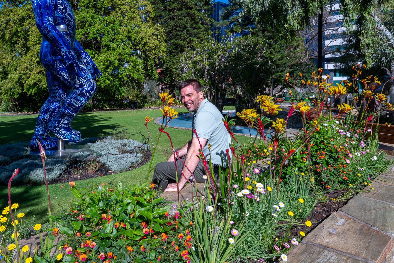 A City of Perth staff member with spring plantings in Stirling Gardens