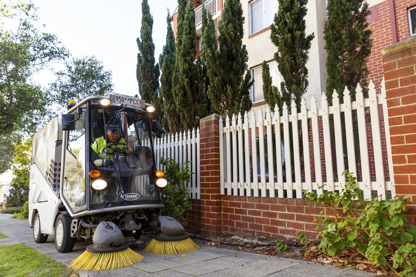 Street sweeper cleaning a city footpath