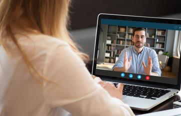 Young woman watching online course on laptop