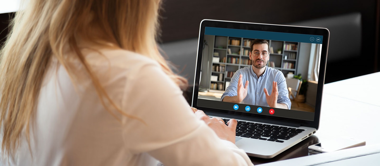 Young woman watching online course on laptop