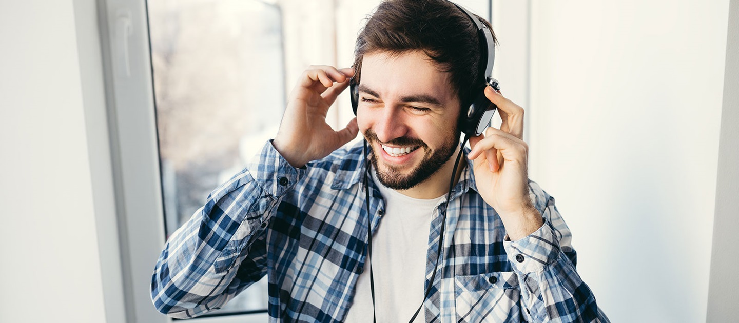Young man listening on headphones