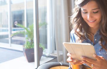 Young woman reading from tablet